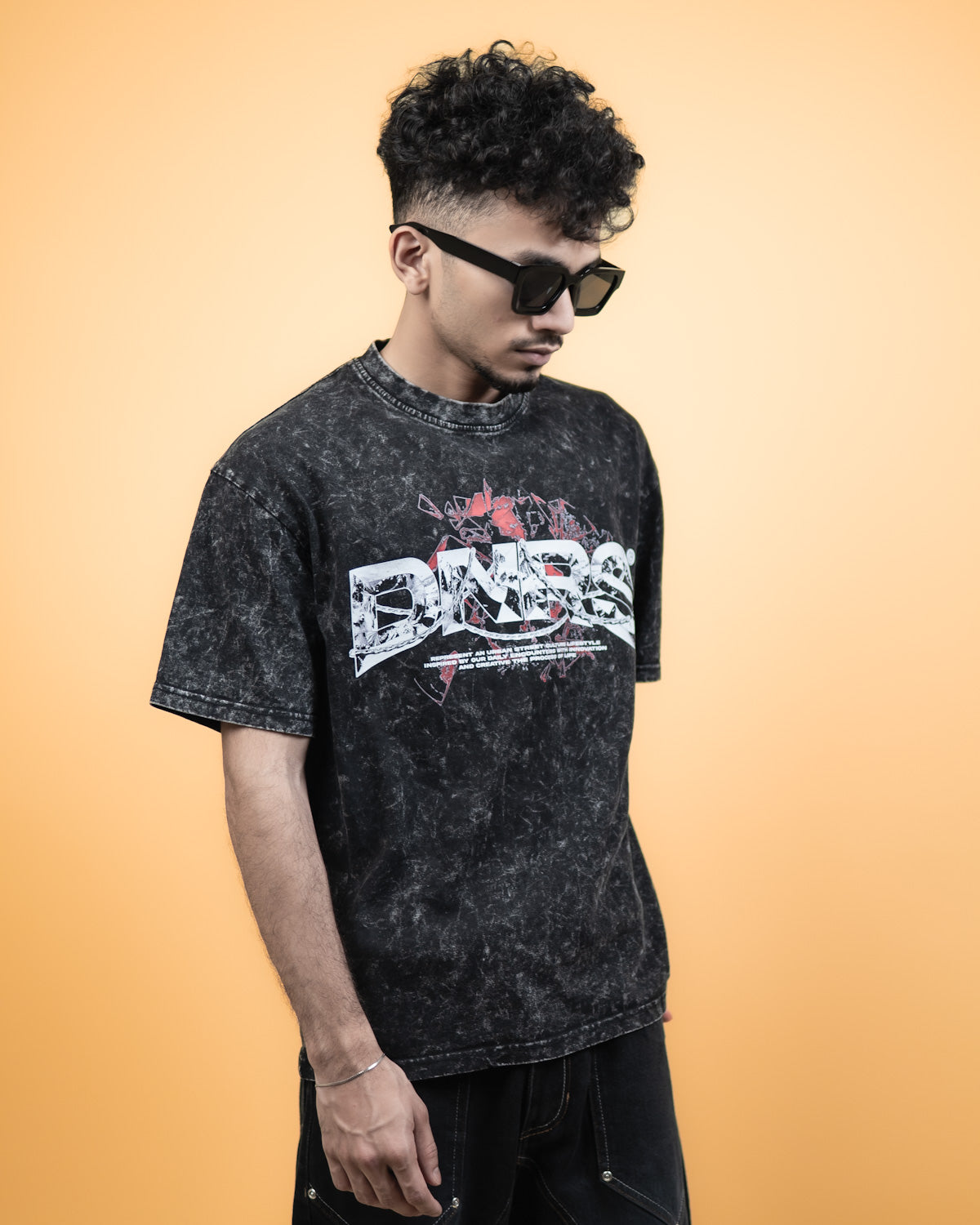 ''DNRS'' Oversized Heavyweight Drop Shoulder T-Shirt In Acid Wash Black.